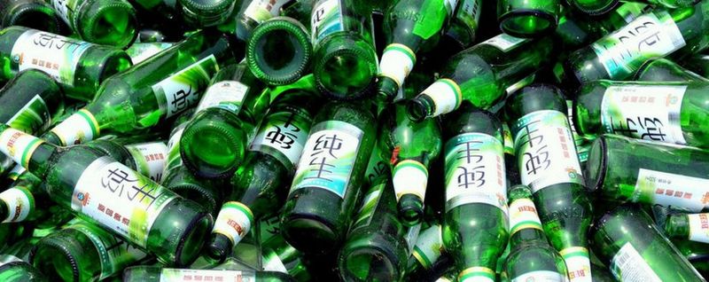 glass bottles piled on to be recycled - SingSaver
