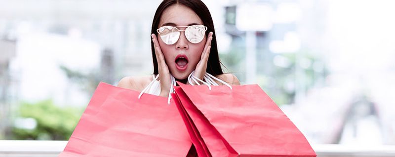 woman shocked with shopping bags -SingSaver